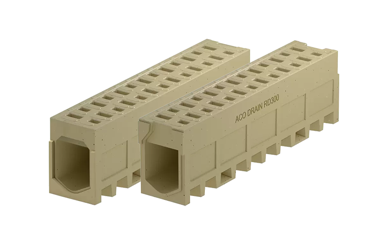 Två beige monolitiska markrännaor med små hål på ovansidan.